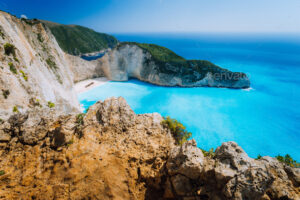 Rock Cliffs in front of Navagio beach Zakynthos. Shipwreck bay with turquoise water and white sand beach. Famous marvel landmark location in Greece.
